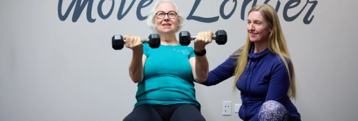 Movement Med Woman on Ball with Weights in each hand